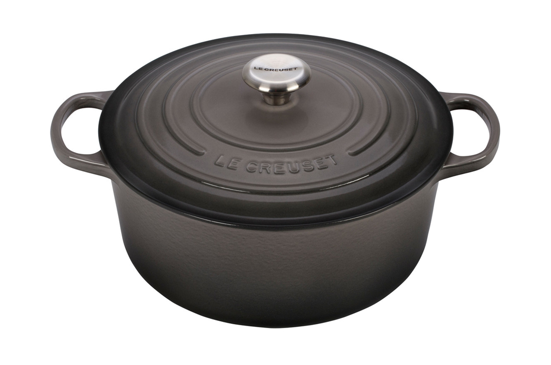 Black Le Creuset cast iron Dutch oven with lid on white background