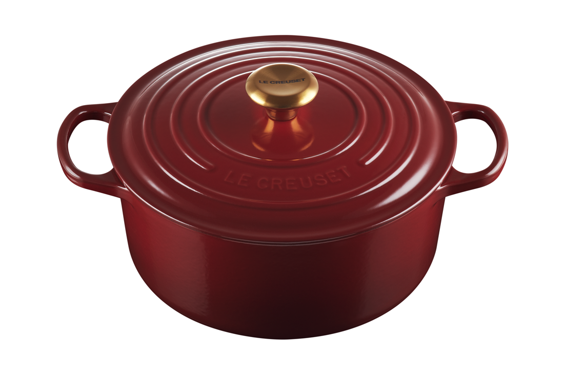 Red Le Creuset cast iron Dutch oven on white background