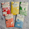 Assorted LeRoux chocolate bars with unique flavors on marble surface