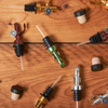 Assorted wine openers and stoppers on a wooden table.