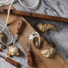 Fresh oysters with open shells, knives, and nautical rope on rustic wooden board