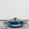 Blue Le Creuset cast iron casserole dish on kitchen counter