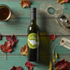 Bottle of LeRoux vinegar with autumn leaves on a wooden table