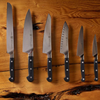 Set of six chef knives arranged in ascending size on a wooden background